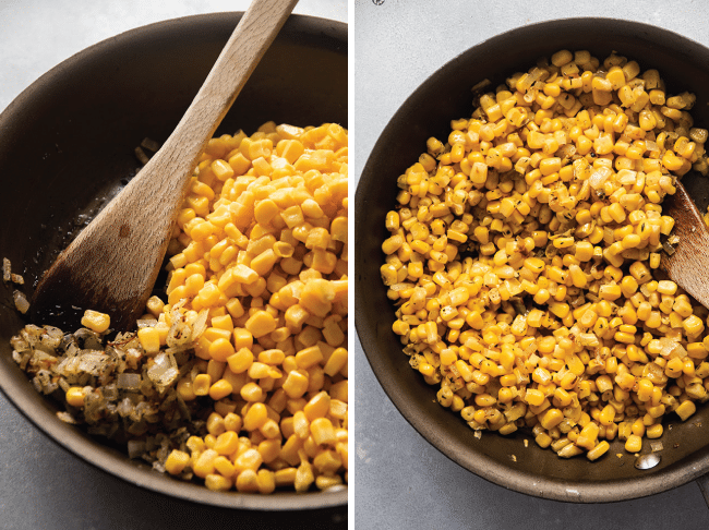 Wooden spoon stirring corn and onions in a skillet.