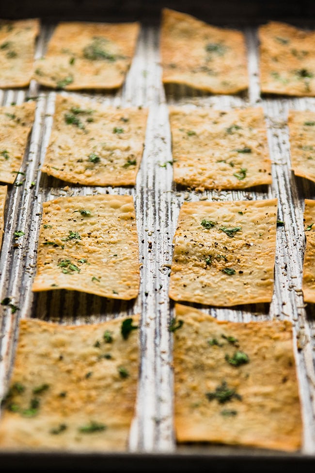 Baked wonton crackers on a sheet pan.