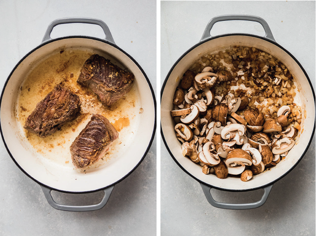 Seared short ribs and sliced mushrooms in a grey dutch oven.