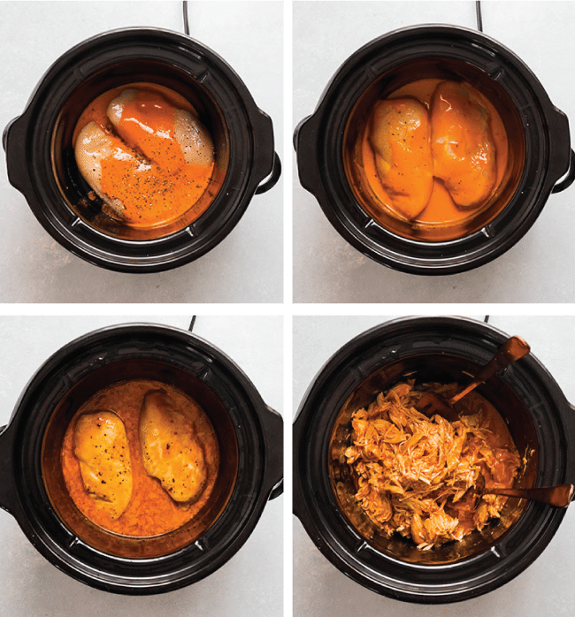 Chicken breasts and buffalo sauce in the bowl of a black slow cooker.
