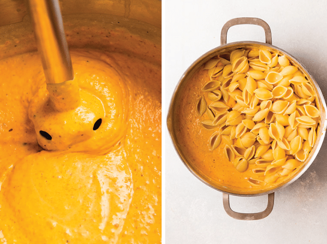 Immersion blender stirring butternut squash sauce in a large saucepan next to a pot filled with cooked pasta.