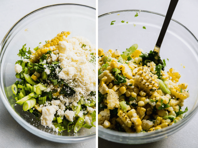 Spoon stirring grilled corn, cilantro, and green onions together in a glass mixing bowl.