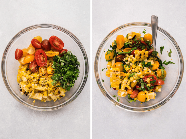 Halved cherry tomatoes, grilled corn kernels, and sliced basil being stirred together in a glass bowl.