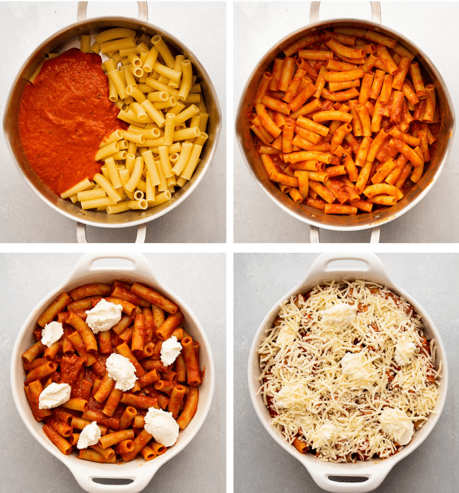 Baked ziti being assembled in a white baking dish.