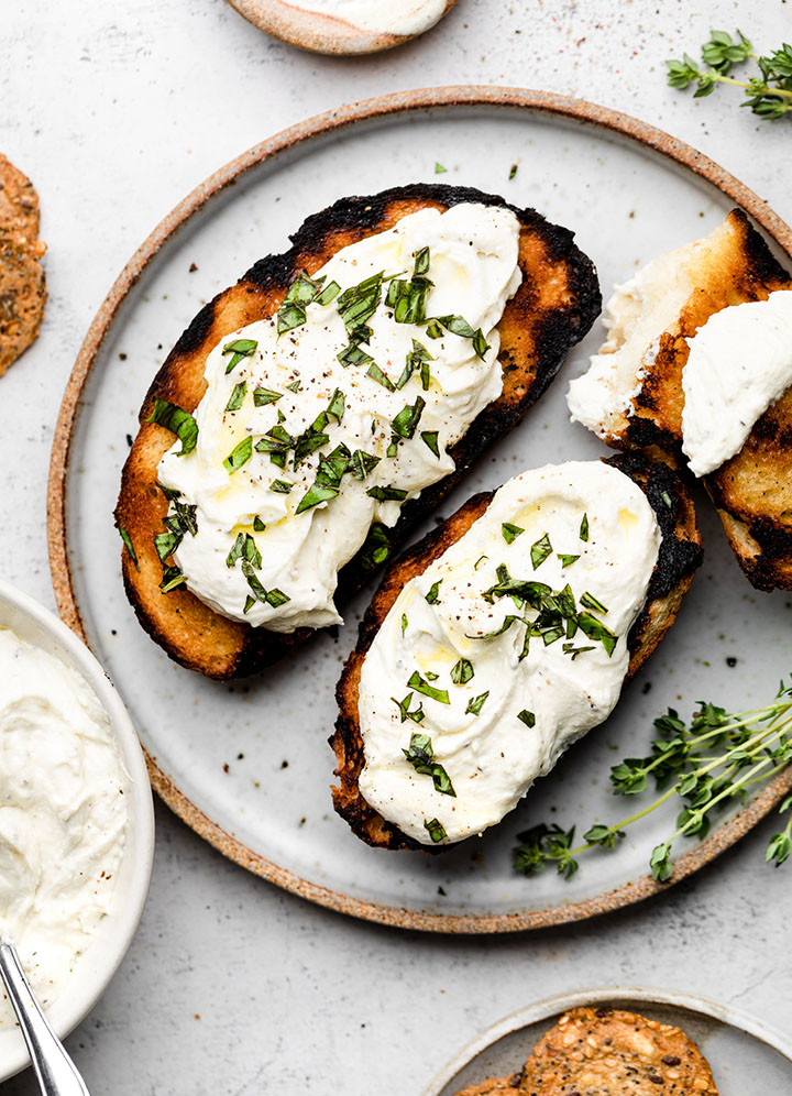 Grilled bread topped with whipped feta, olive oil, and fresh basil.