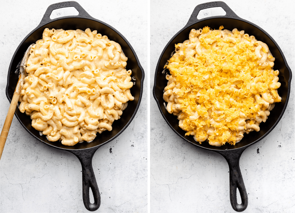 Mac and cheese in a black cast iron skillet, topped with shredded cheese.