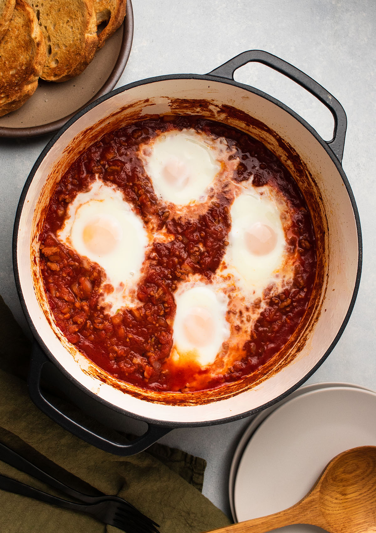 Baked eggs in a large black pot.