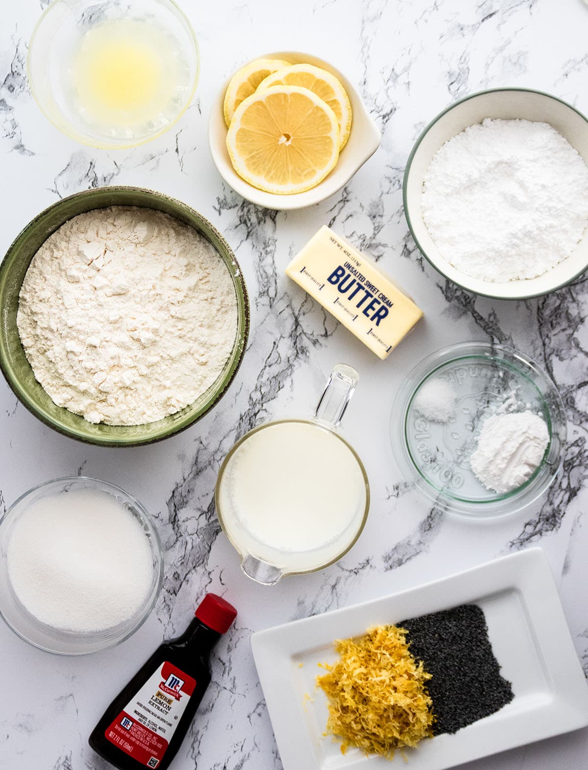 Scone ingredients, measured into individual prep bowls on a white table.