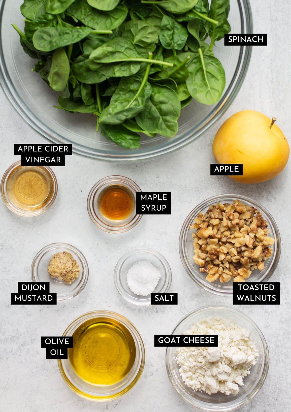 Salad ingredients, measured out into individual glass bowls.