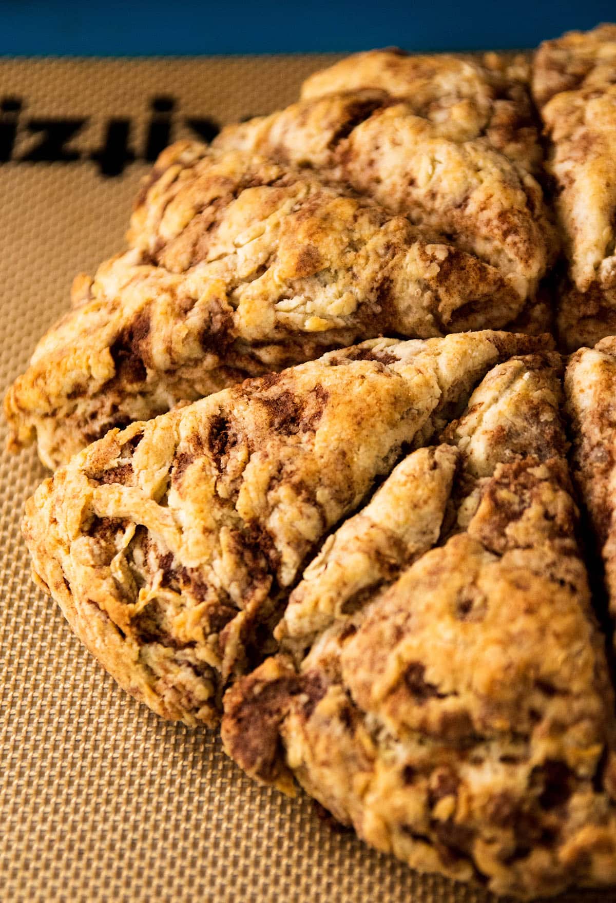 Cinnamon scones on a nonstick baking mat.