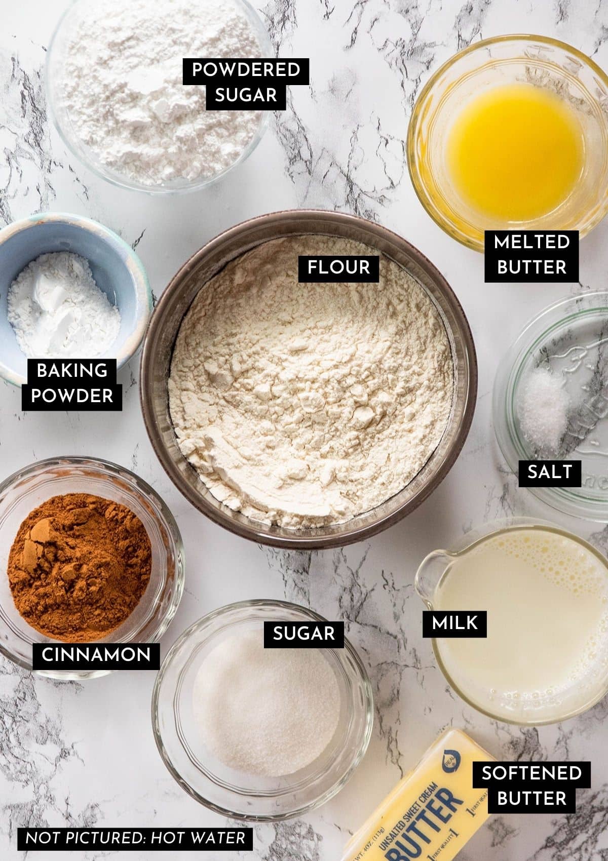 Scone ingredients, organized into individual bowls on a marble countertop.