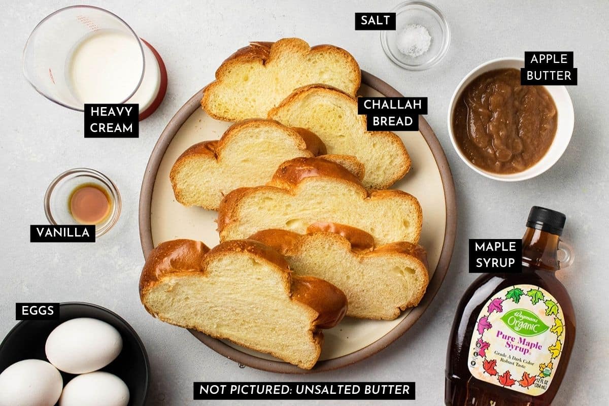 French toast ingredients, organized into individual bowls on a white table.