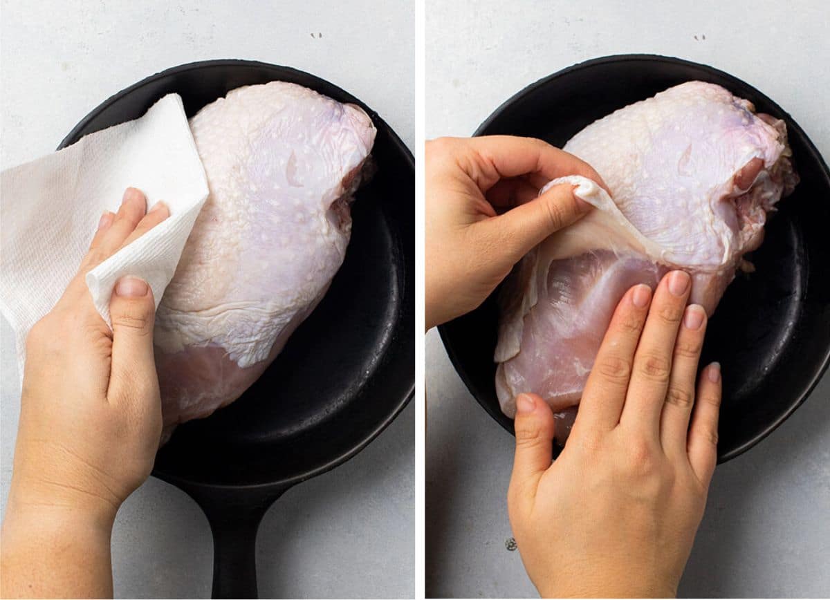 Patting turkey breast dry with a paper towel.