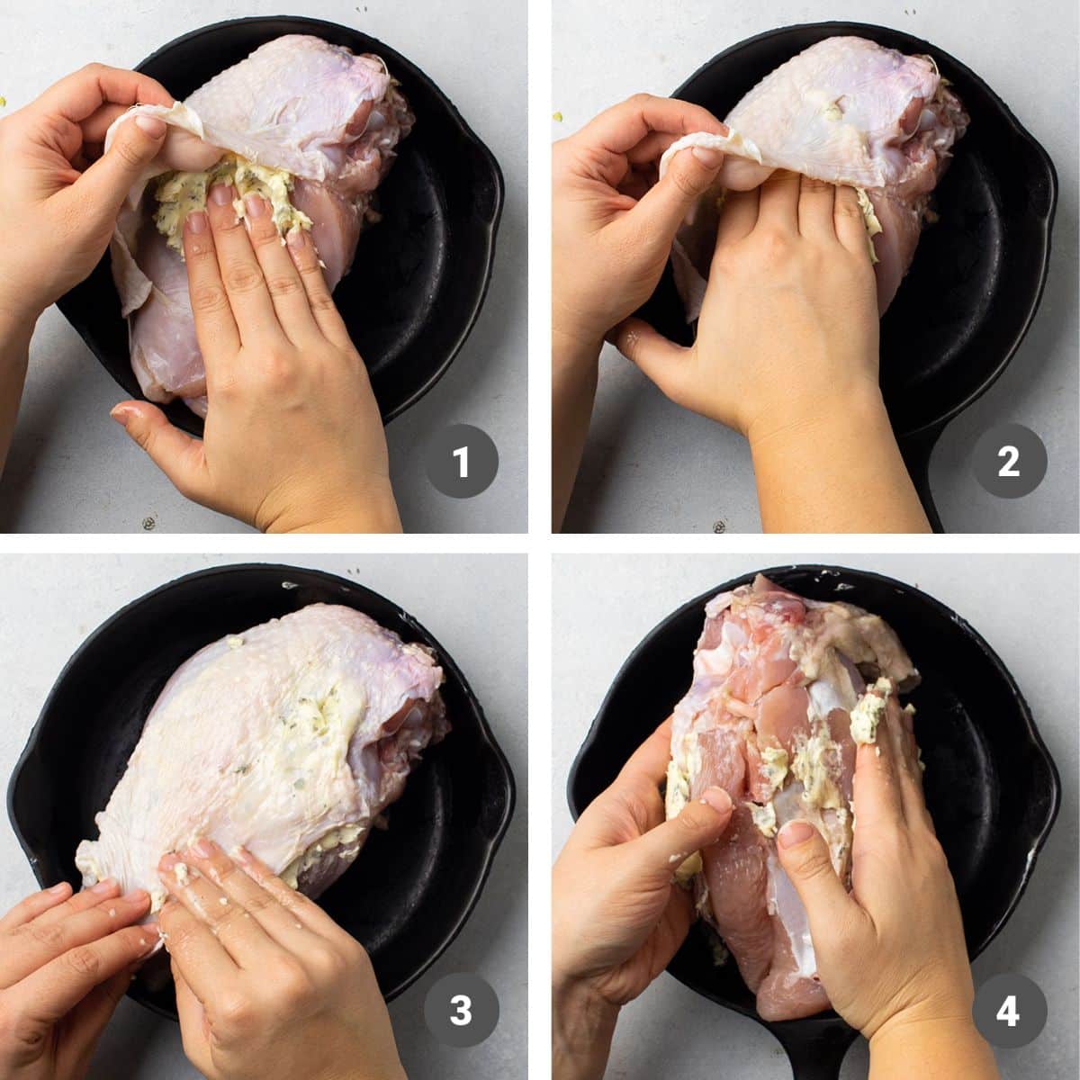 Hands spreading compound butter under the skin of a turkey breast.