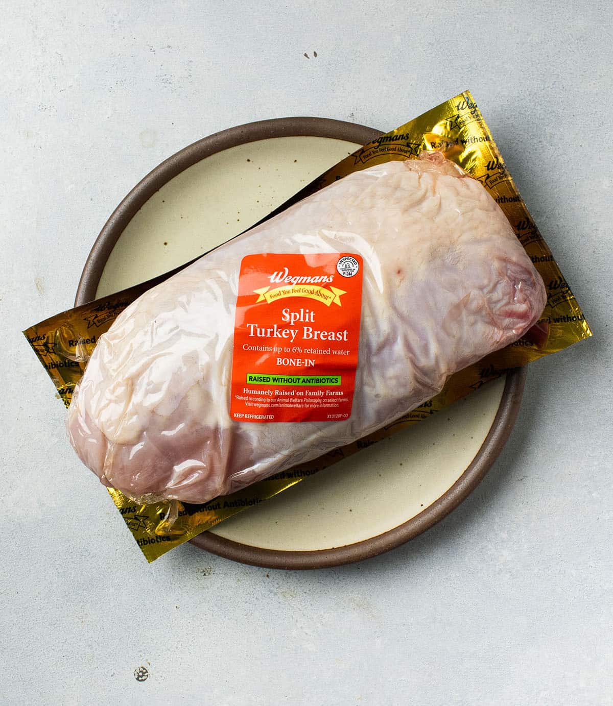 Split turkey breast in its packaging on a white table.
