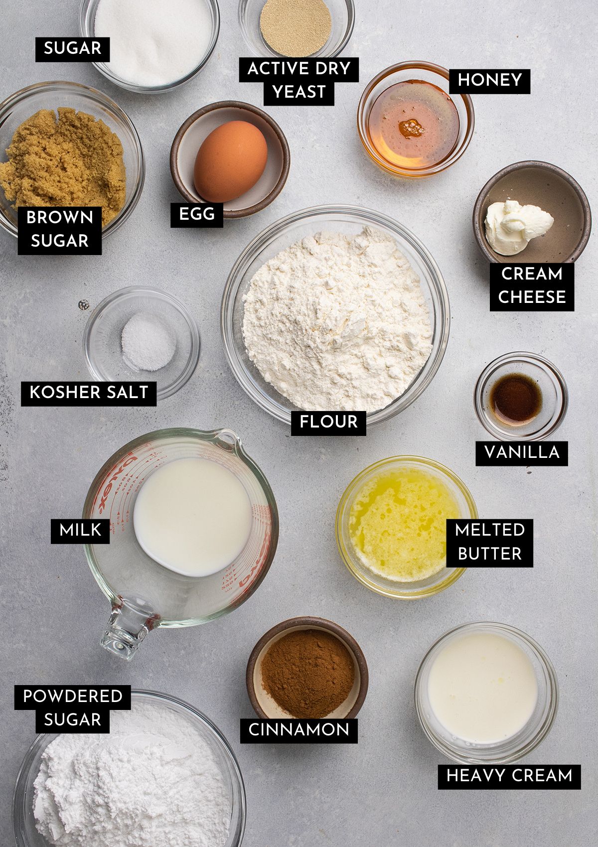 Cinnamon roll ingredients on a white table.