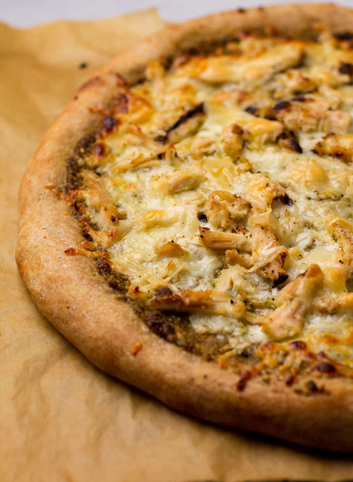 Whole wheat pizza topped with chicken and mozzarella cheese.