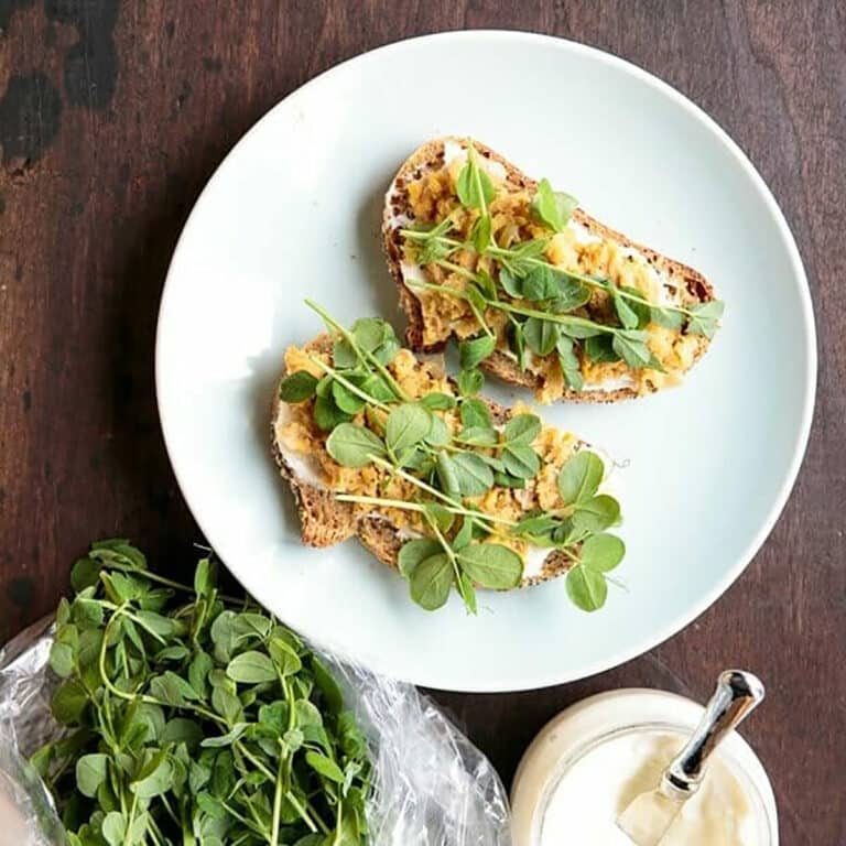 Pea shoots on toast with mashed chick peas.