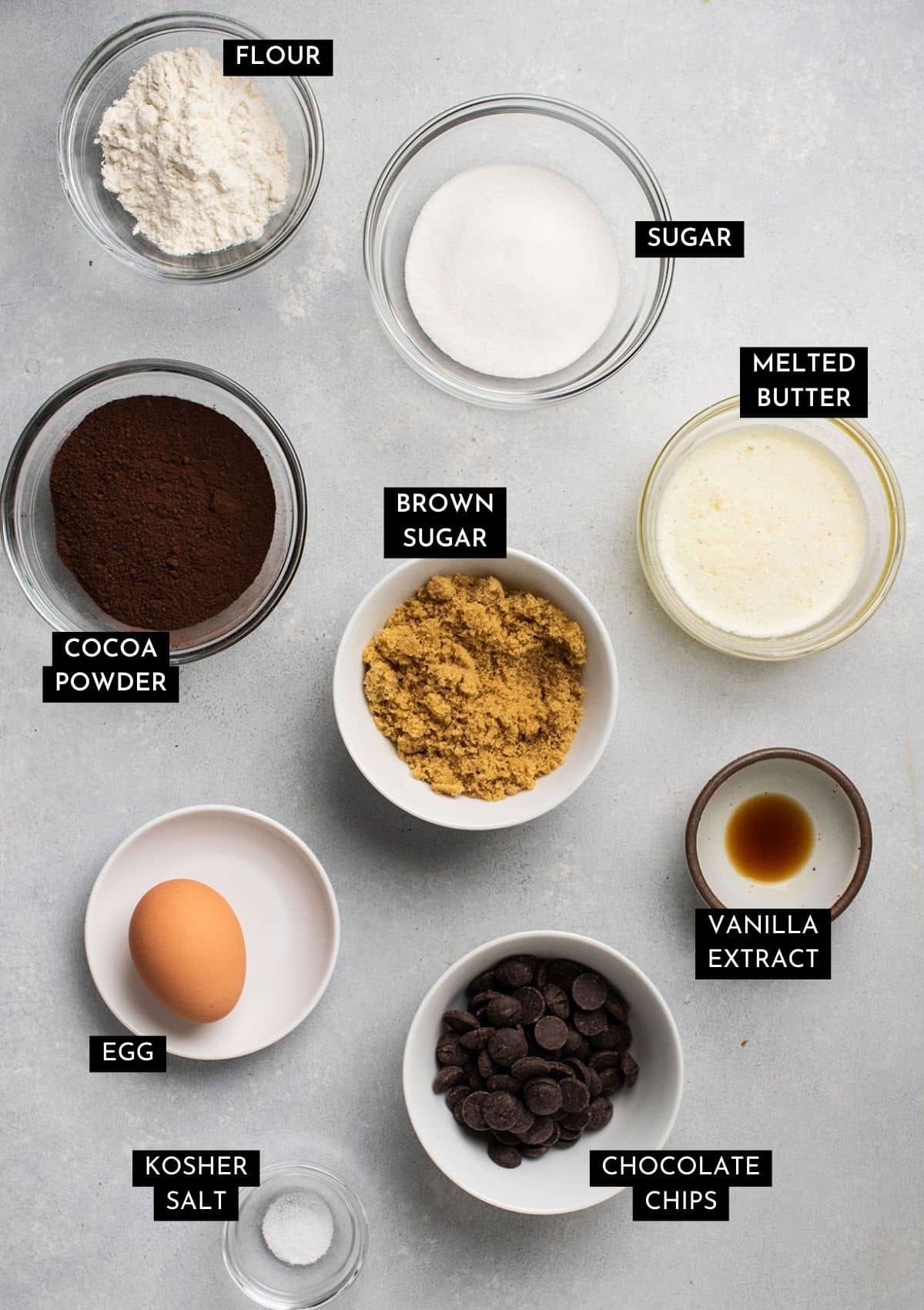 Brownie ingredients, organized into individual bowls on a white table.