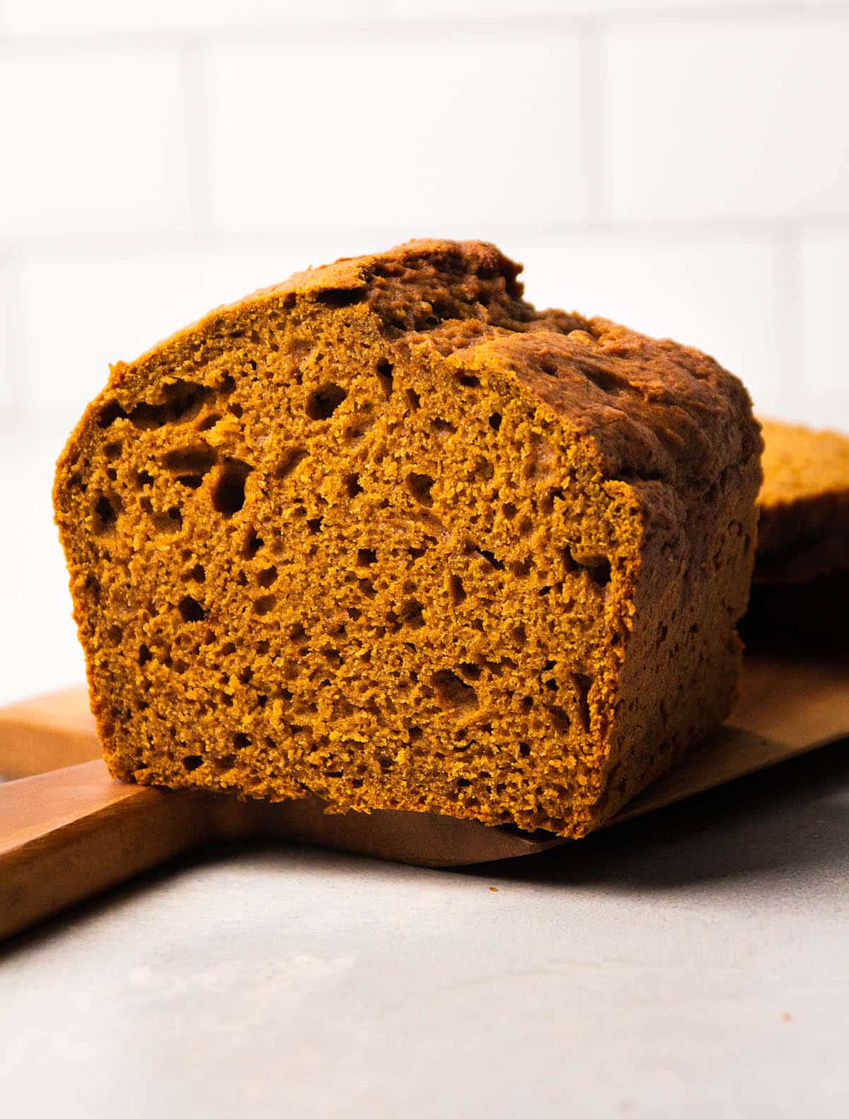 A loaf of pumpkin bread, sliced in half.