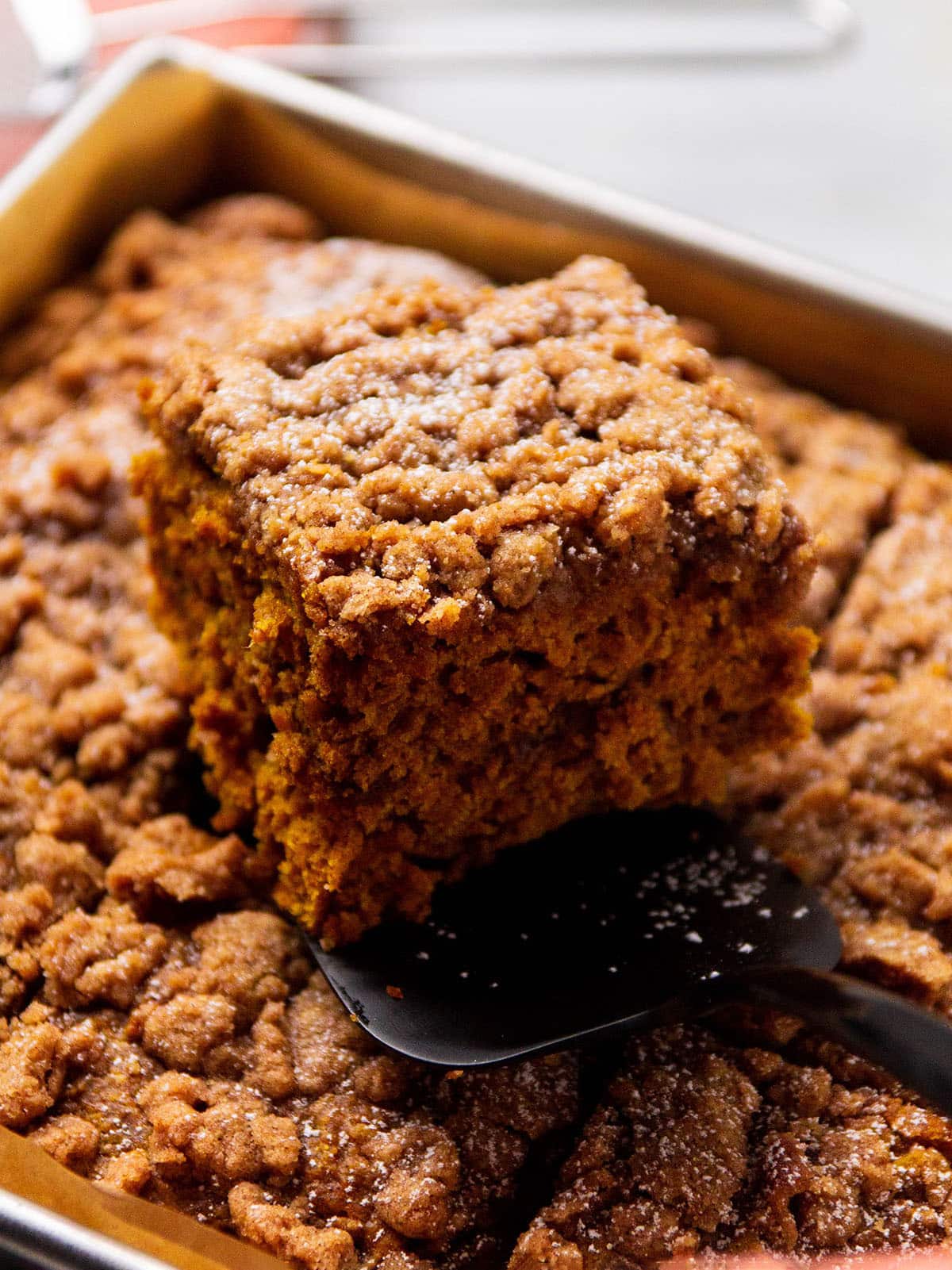 Cutting a piece of pumpkin coffee cake.