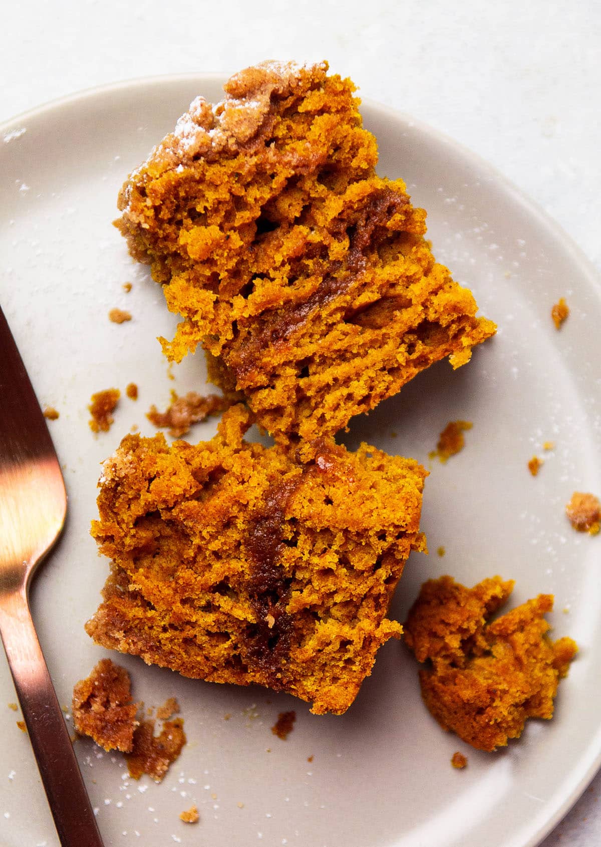 Slice of coffee cake, split in half to reveal the dark filling.