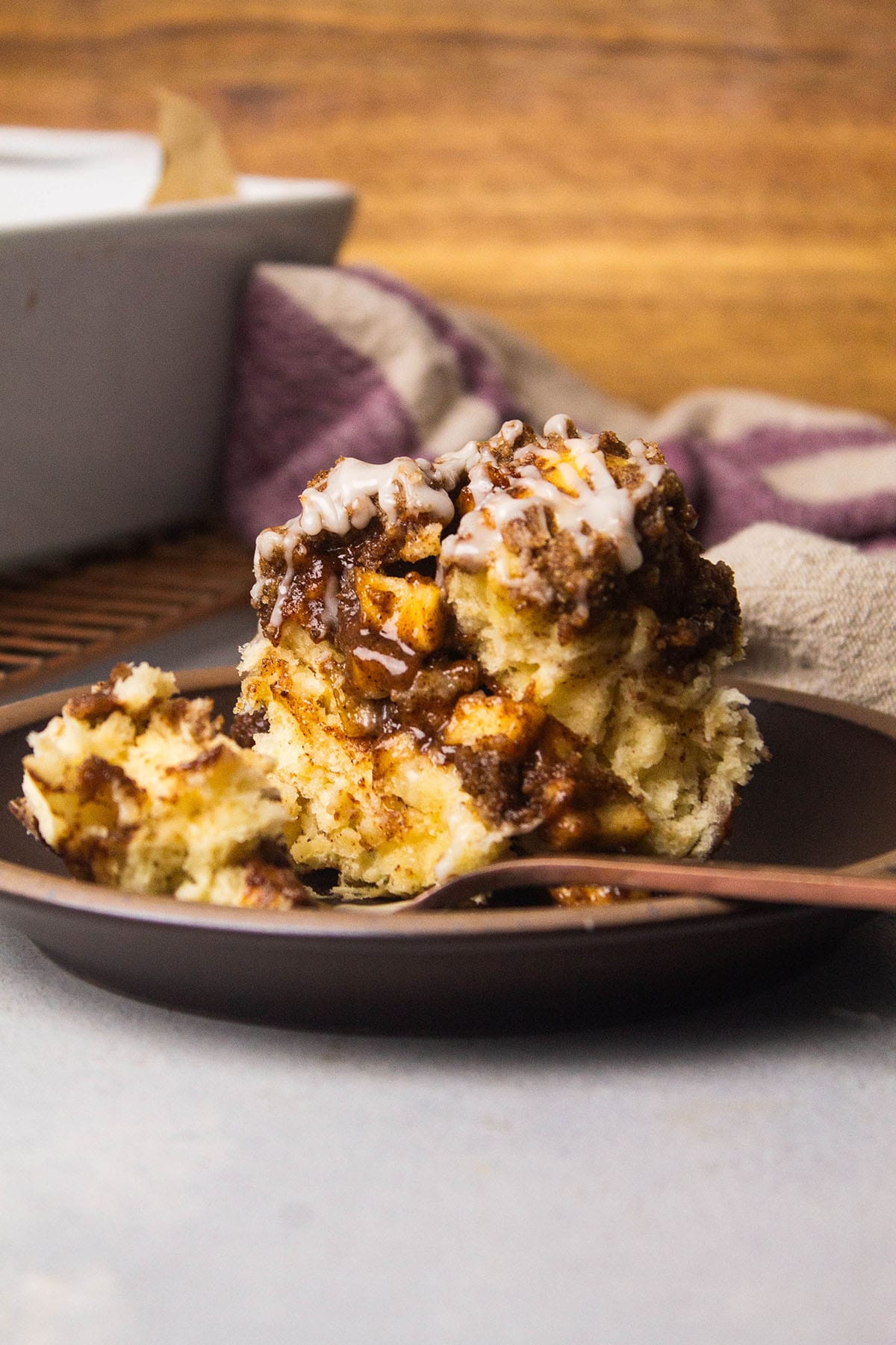 Apple pie cinnamon roll on a plate.