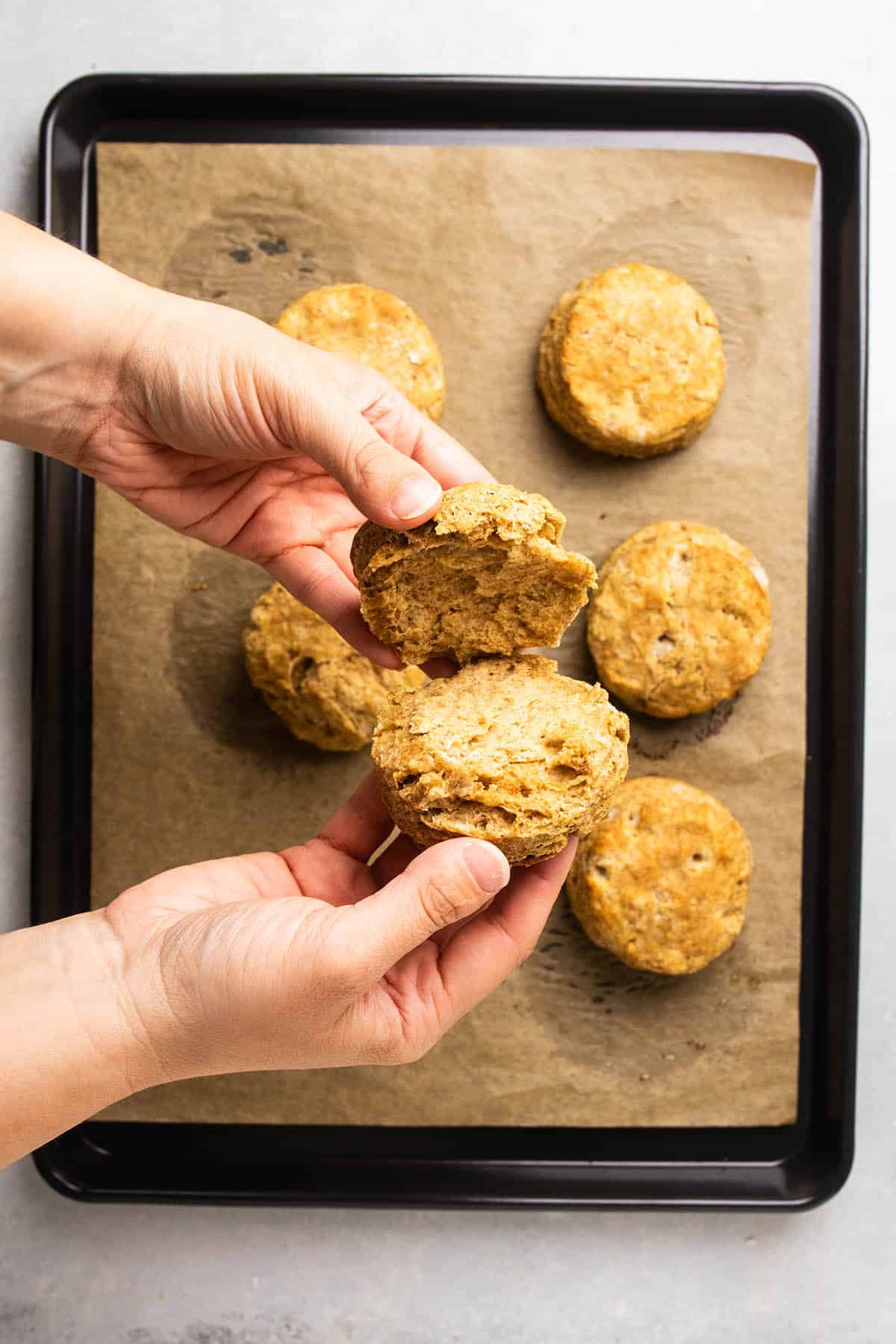 Pulling a biscuit apart to show the interior layers.