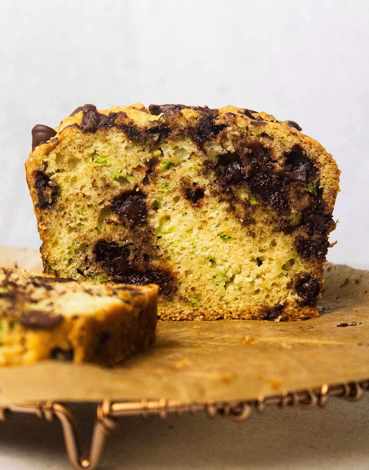 Zucchini chocolate chip loaf, sliced in half to show interior texture.