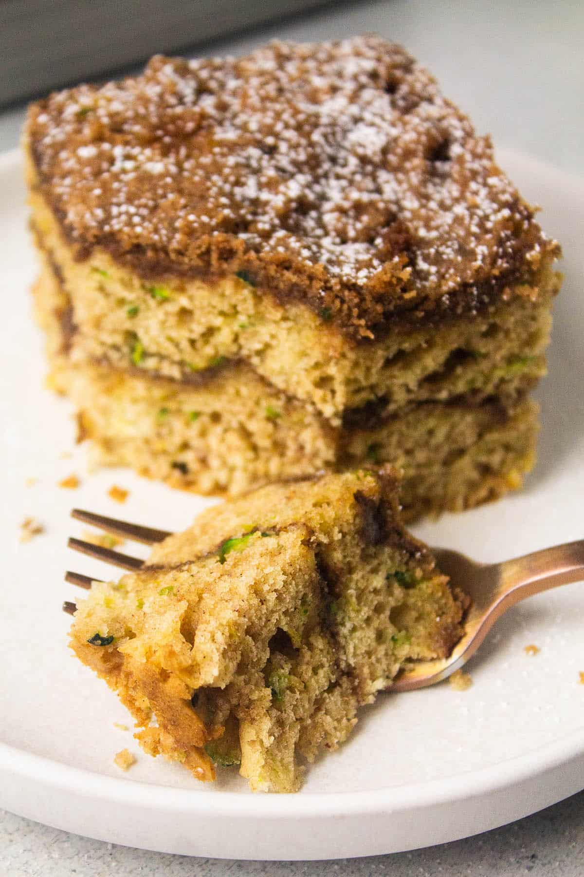 Fork taking a bite of coffee cake.