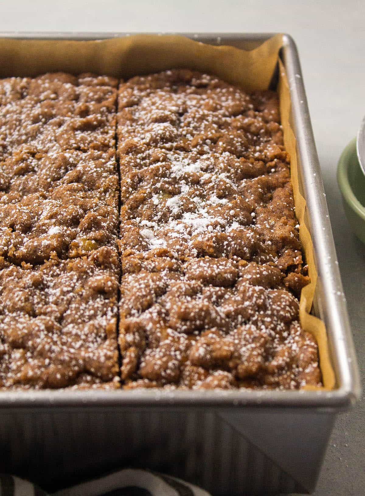 Zucchini crumb cake with powdered sugar.